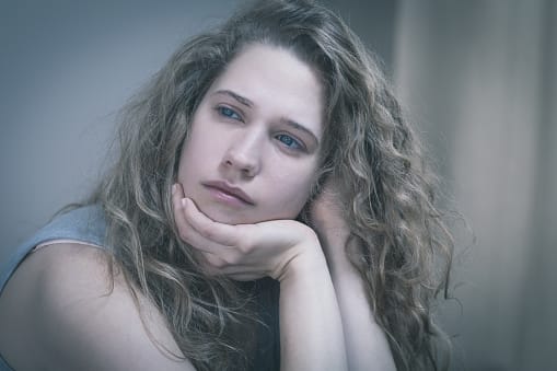 Young woman with sad eyes realizes there are many types of addiction.