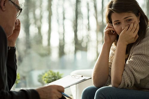 Woman speaking with counselor about inpatient detoxification.