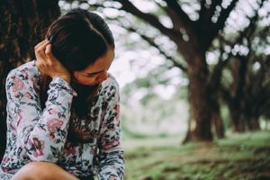 Woman facing away from camera wondering what helps with kratom withdrawal