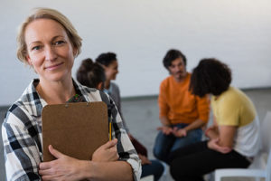 woman leading a group therapy session at a heroin rehab center west palm beach